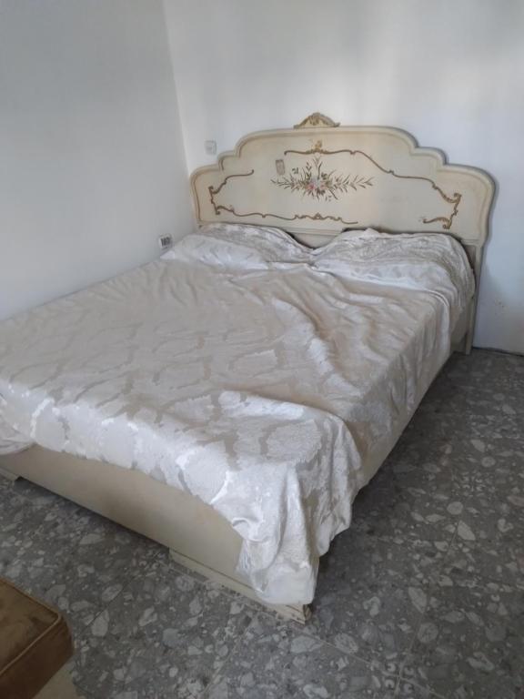 a bed in a bedroom with a white bedspread at Moon light in Jerusalem