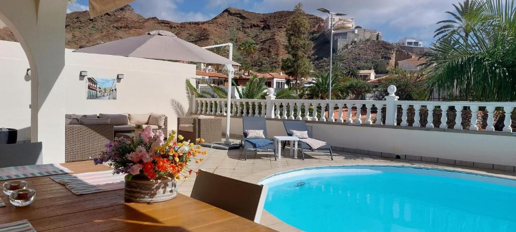 a villa with a swimming pool and a patio at Villa Tauro Beach & Golf in La Playa de Tauro