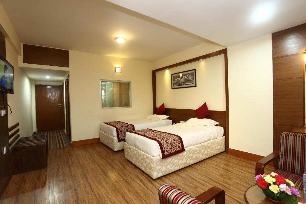 Postel nebo postele na pokoji v ubytování Hotel Woodland Kathmandu
