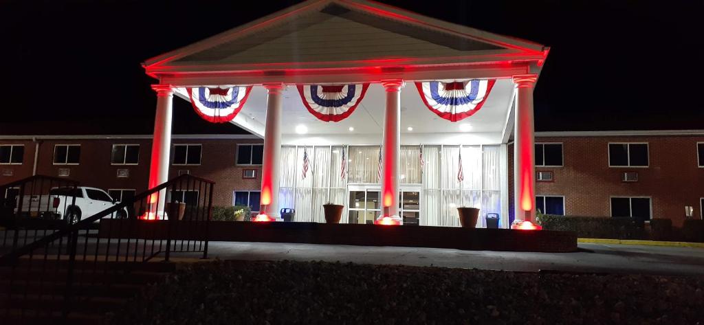 a gazebo with red lights in front of a building at Americas Best Value Inn Phenix City in Phenix City