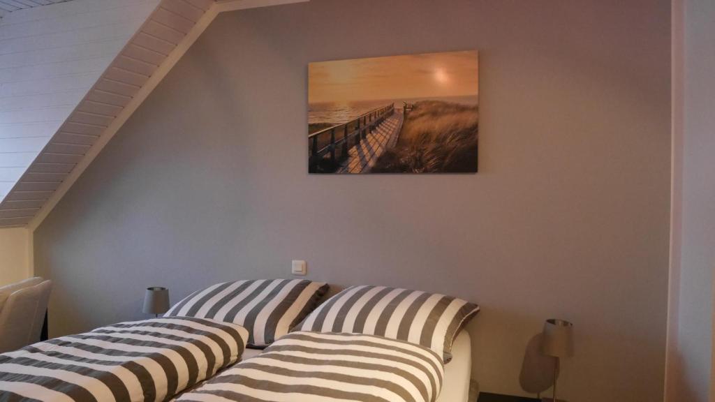 two striped beds in a room with a painting on the wall at Ruhiges Zimmer Nähe Nürnberg Messe mit Wallbox in Nürnberg