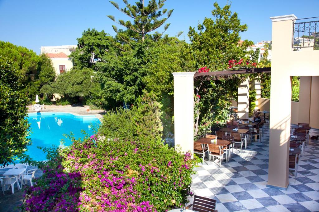 a view of the pool at a resort with flowers at Kalydna Island Hotel in Panormos Kalymnos