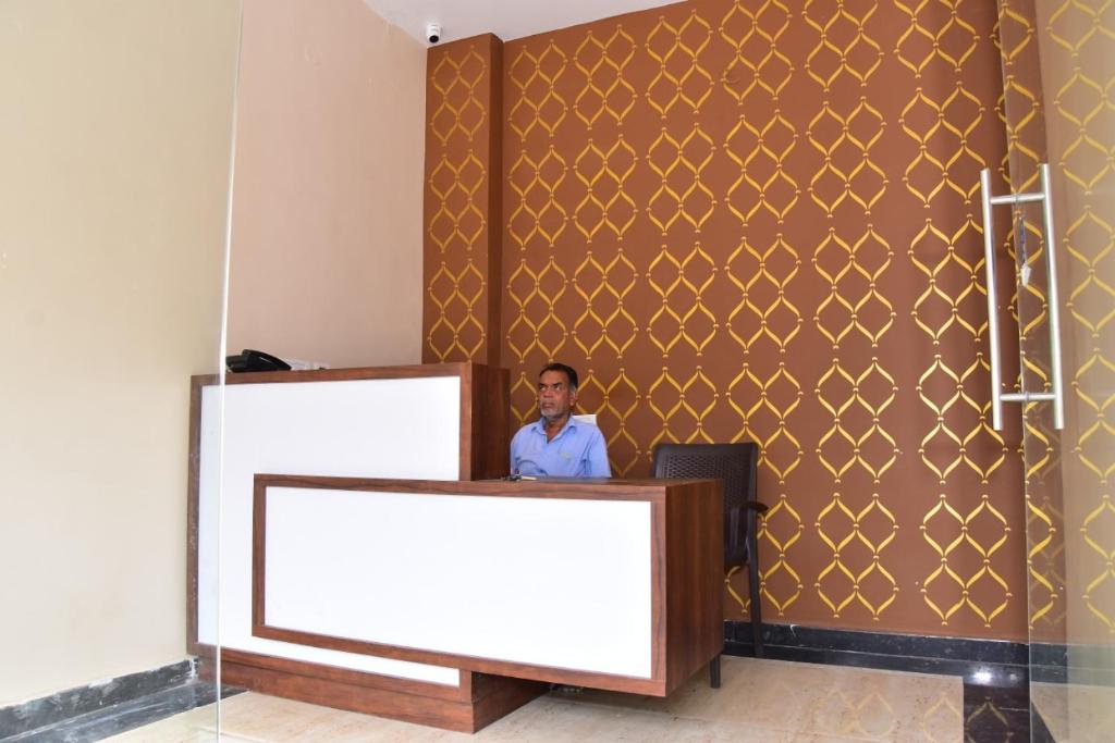 a man is standing behind a podium in a room at CHANDRA ROYAL RESIDENCY in Vellore