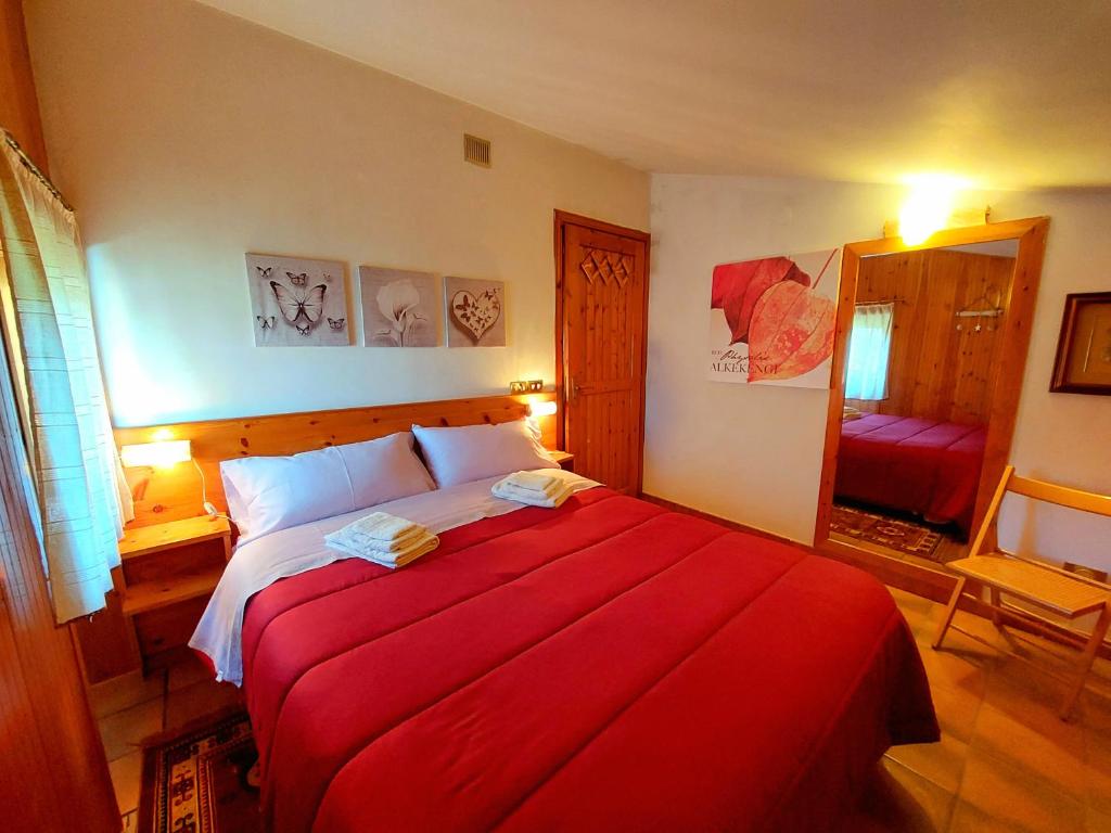 a bedroom with a large red bed in a room at repaci 17 home in Camigliatello Silano