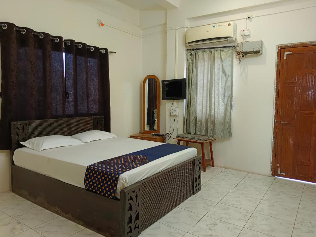 a bedroom with a bed and a television in it at Bhavani Residency in Dapoli