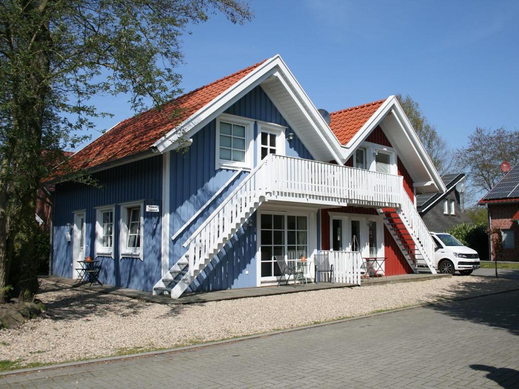 una casa azul con techo rojo en Apartments im Schwedenstil, en Papenburg
