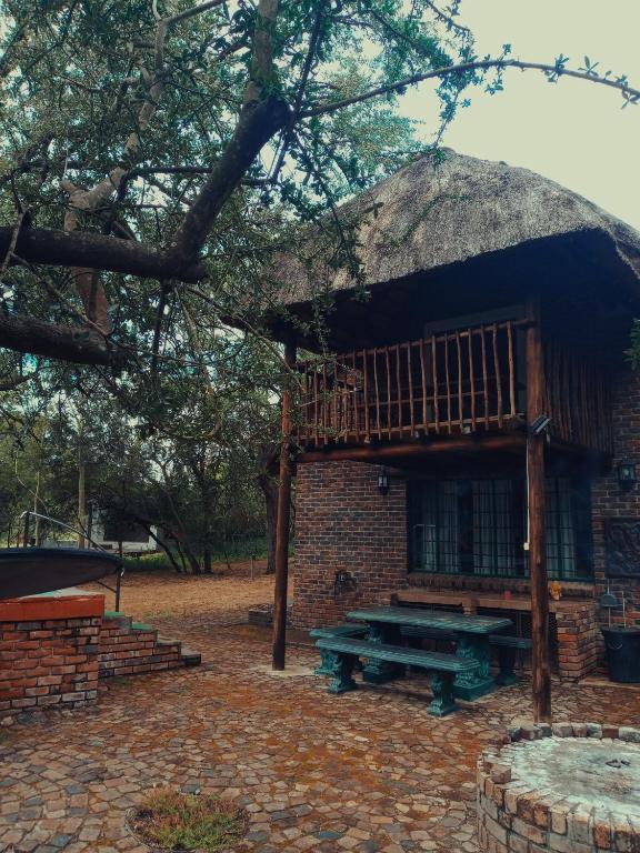 a hut with a picnic table in front of it at Carpe Diem in Marloth Park