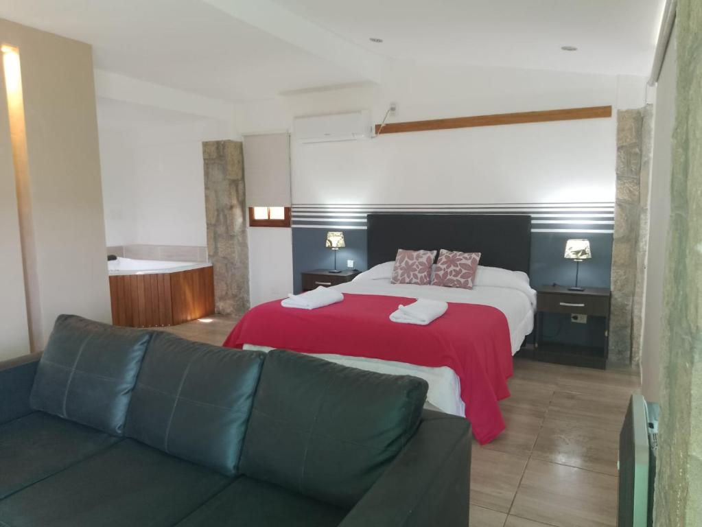 a hotel room with a bed and a couch at InterLaken Apart & Suites in Villa Carlos Paz