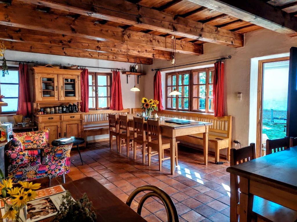 a kitchen and dining room with a table and chairs at Apartmány Červený Dvůr in Chvalšiny
