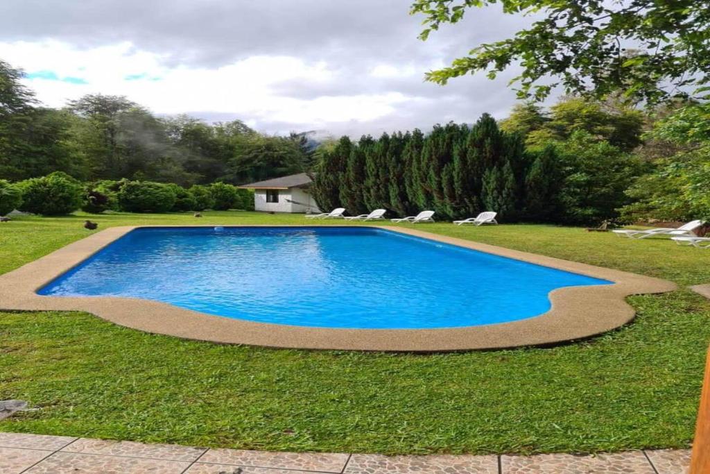 a swimming pool in the middle of a yard at Orillas del Coilaco in Pucón