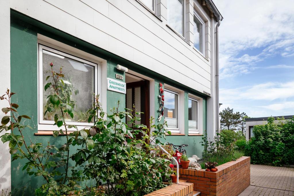 a green house with plants outside of it at Greenhouse Apartments in Helgoland