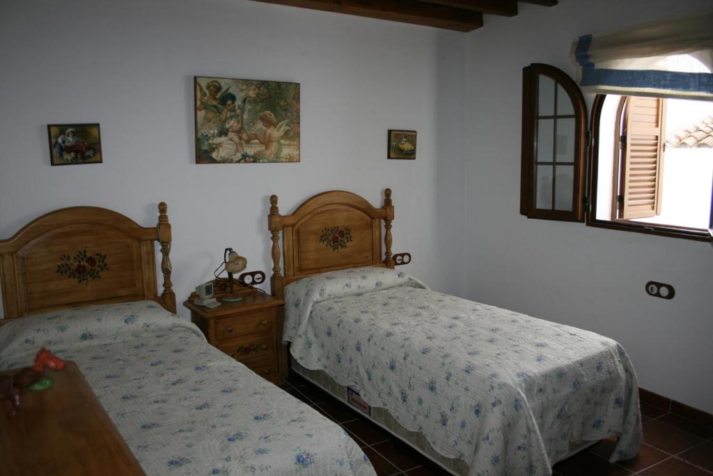 Кровать или кровати в номере Casa Lentegí