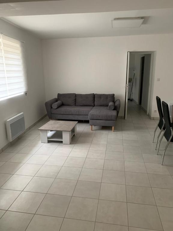 a living room with a couch and a table at gite a la campagne in La Chapelle-Onzerain