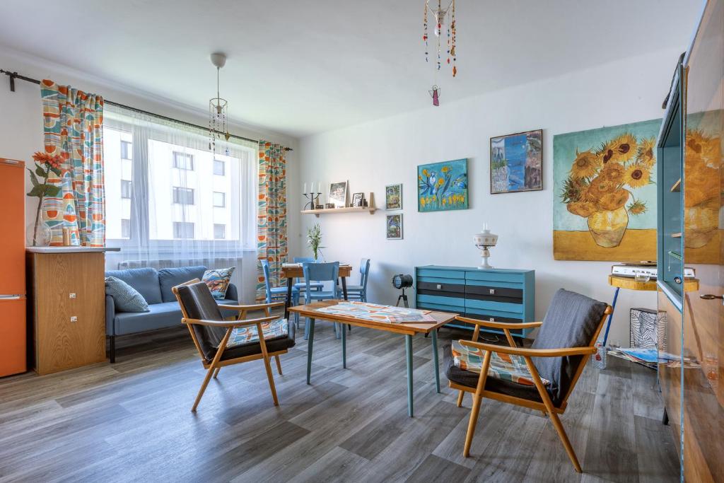 a living room with a table and chairs and a couch at Retro Art room in Lomnice nad Popelkou