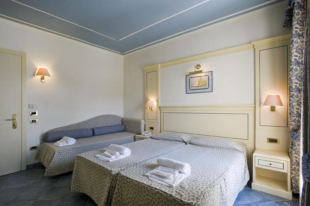 Postel nebo postele na pokoji v ubytování Hotel Poseidon