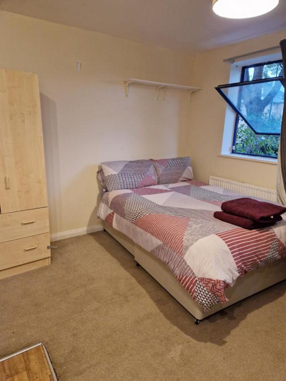 a bedroom with two beds and a window at Chique Maidstone Studio III in Kent