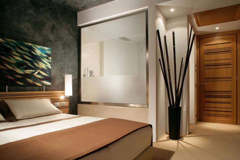 a bedroom with a bed and a painting on the wall at Sea Art Hotel in Vado Ligure