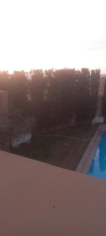 a view of a yard and a swimming pool at Villa à louer dans un endroit magnifique in Tifnit