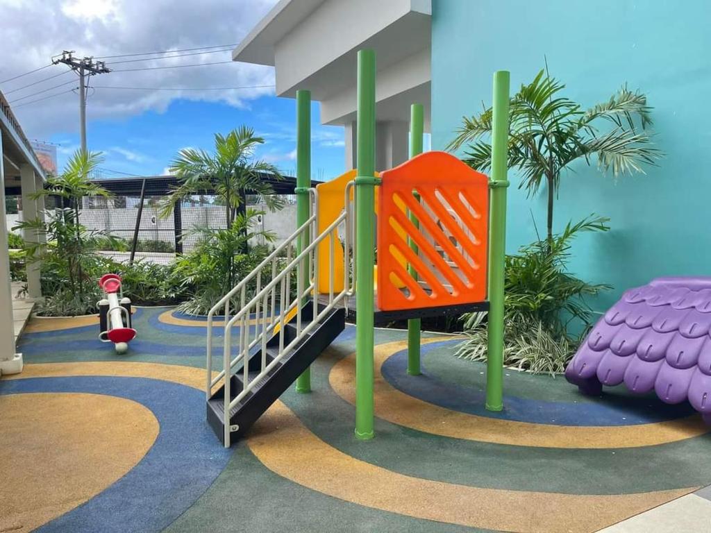 a playground with a slide in a building at mesavirre garden residences in Bacolod