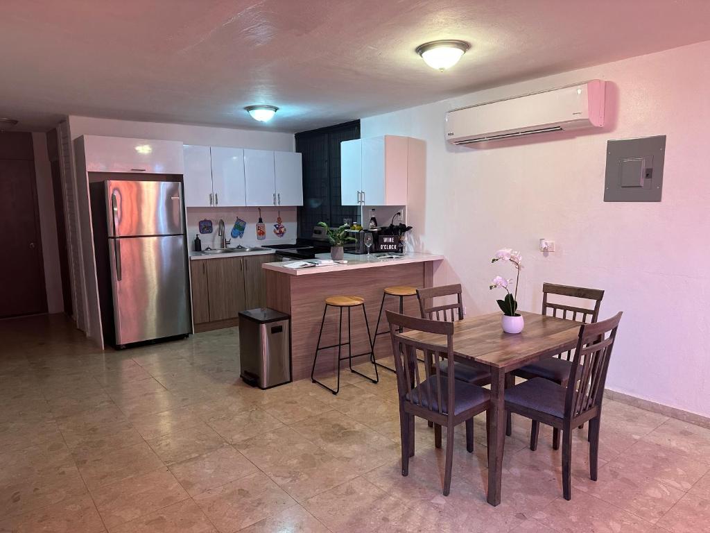 a kitchen with a table and chairs and a refrigerator at Whole House by Beach - Relaxing & Family Friendly! 