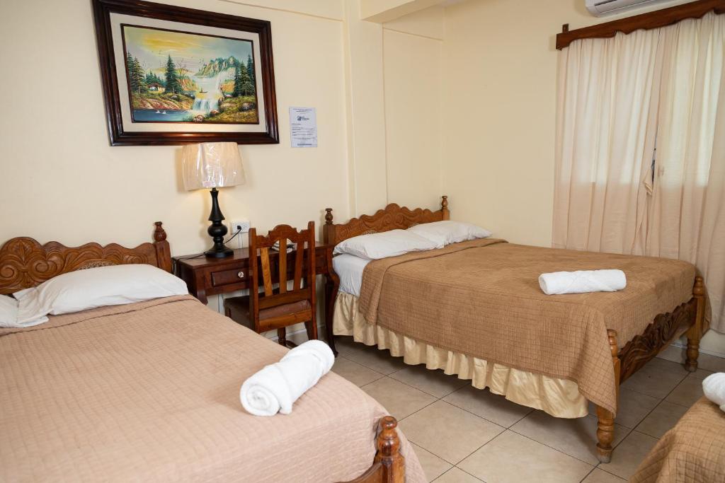 Postel nebo postele na pokoji v ubytování Hotel Internacional Palmerola