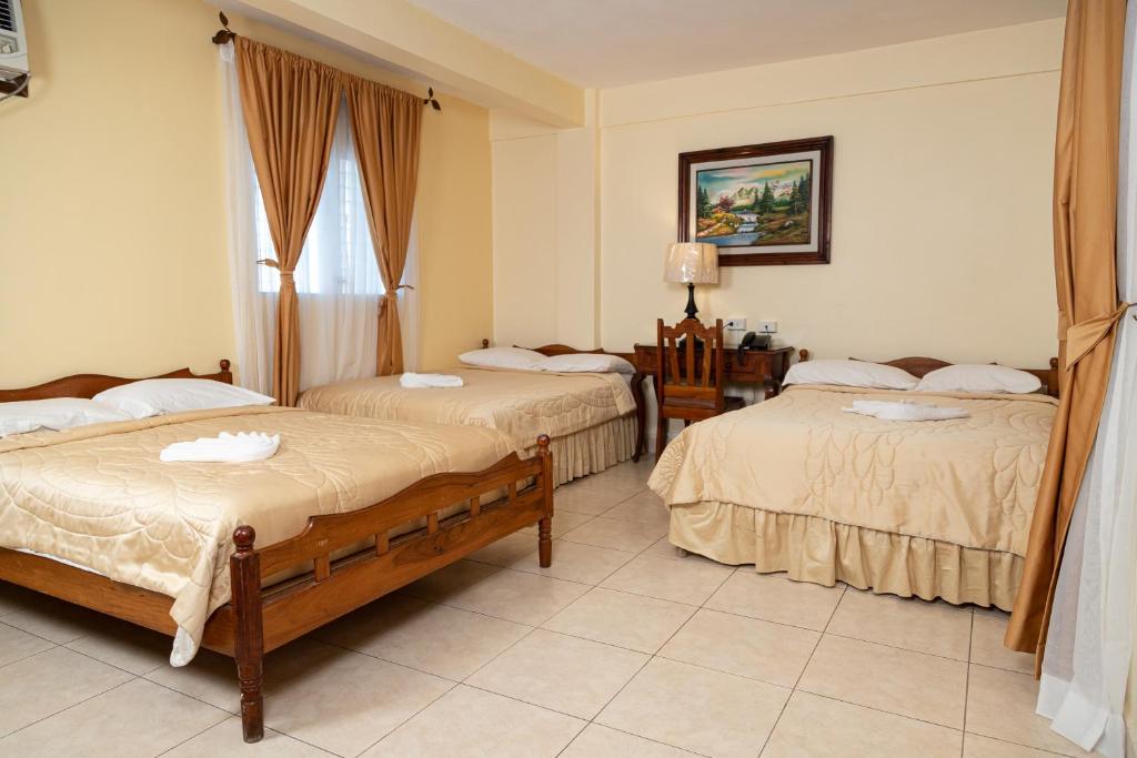 Postel nebo postele na pokoji v ubytování Hotel Internacional Palmerola