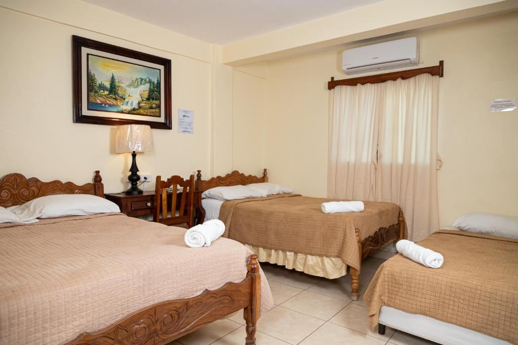 Postel nebo postele na pokoji v ubytování Hotel Internacional Palmerola