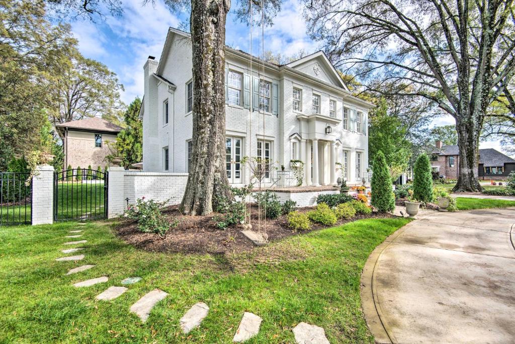 a white house with a tree and a driveway at Stunning Charlotte Home Private Pool! in Charlotte