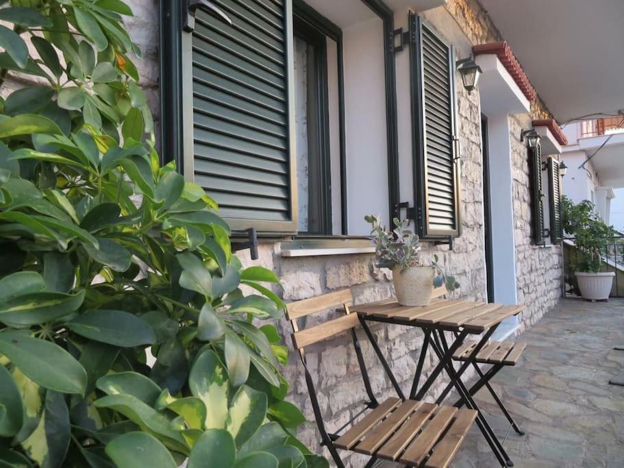 a wooden table and two chairs on a patio at Το Πέτρινο in Aitolikón