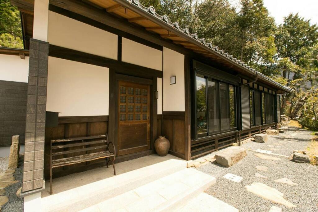 a building with a wooden door and a bench at Traditional/modern Kyoto Paradise in quiet area! in Iwakura