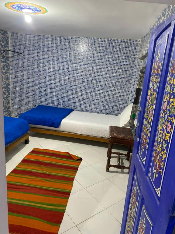 Un ou plusieurs lits dans un hébergement de l'établissement Hostel Essassi 23