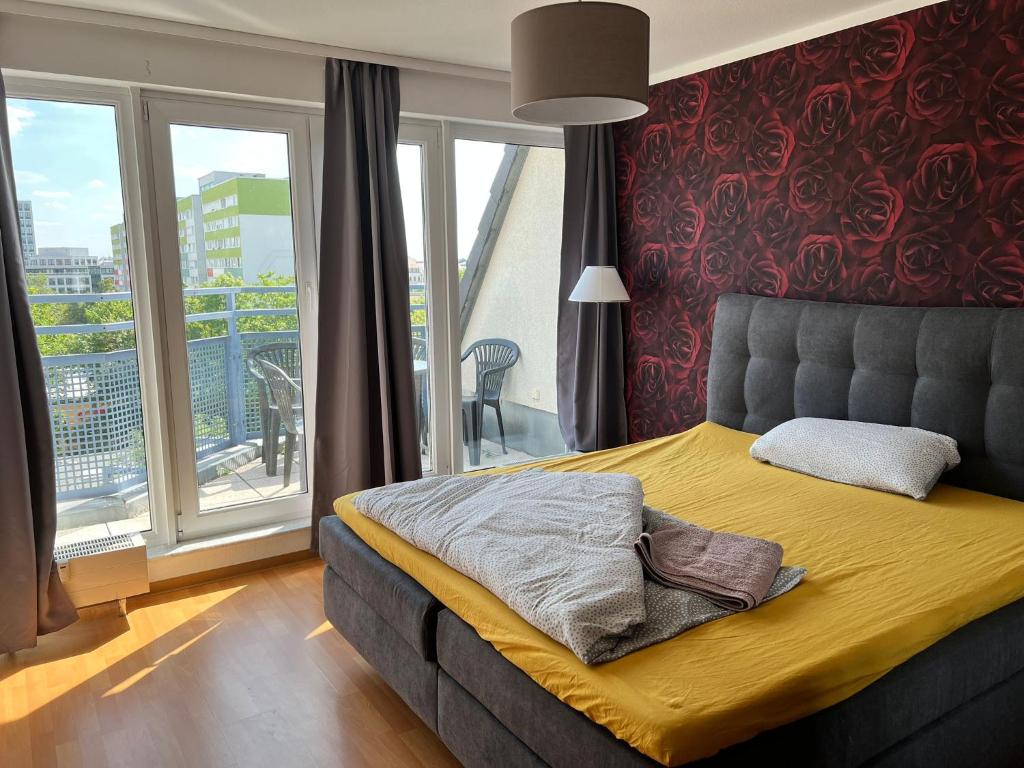 een slaapkamer met een bed en een balkon bij LEA Apartments Zoo Panoramablick mit Terasse in Leipzig