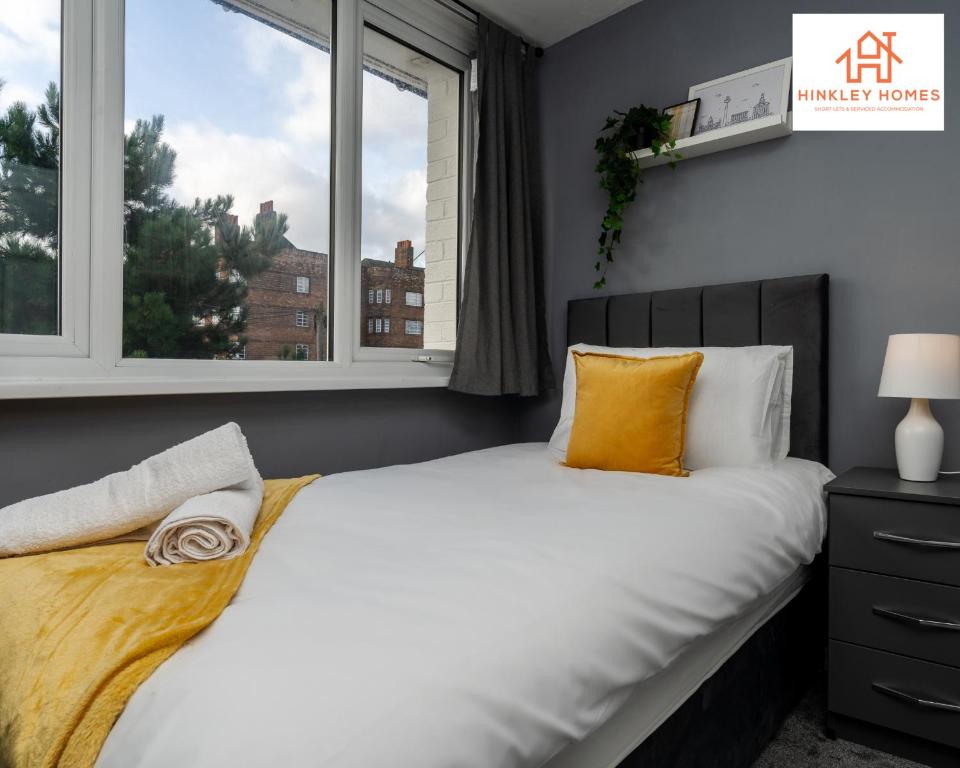 a bedroom with a large bed and a window at Large & Spacious 3 Bedroom House with Parking & Wifi By Hinkley Homes Short Lets & Serviced Accommodation in Liverpool