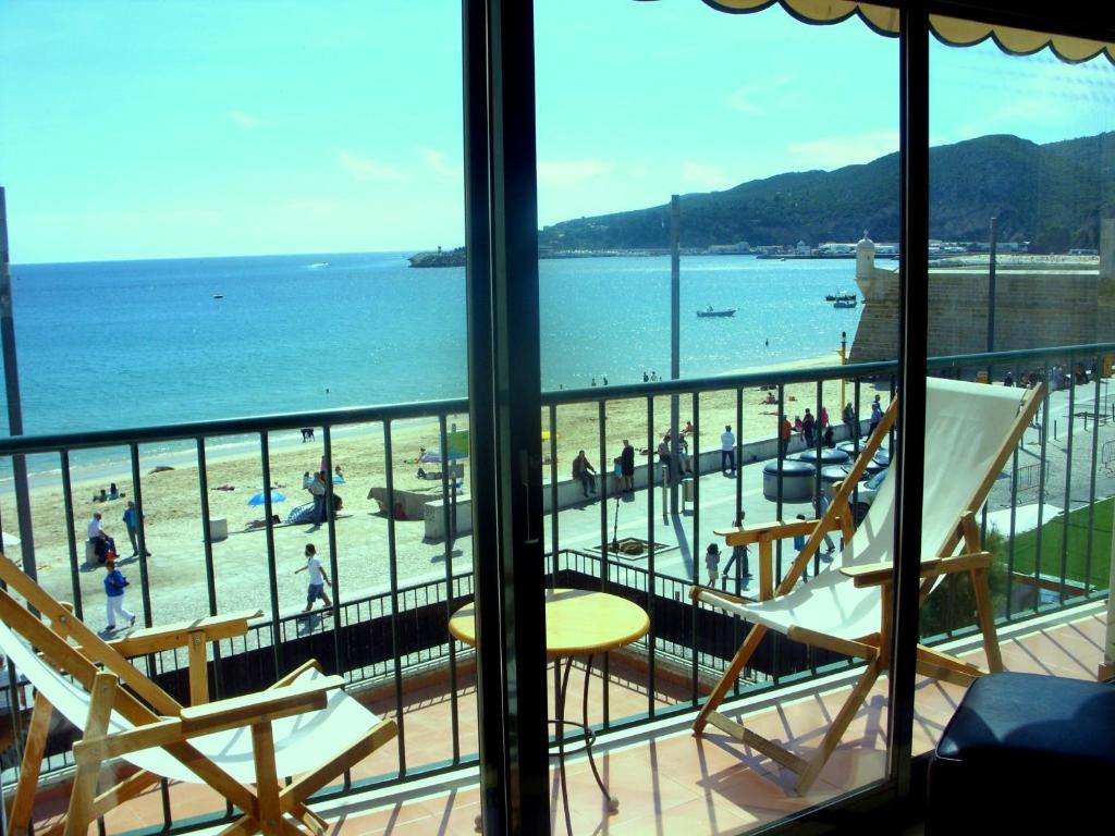 a view of a beach from a room with a balcony at Sesimbra4you in Sesimbra