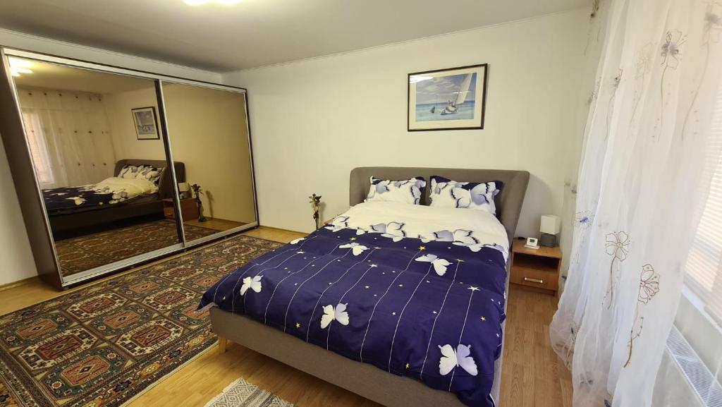 een slaapkamer met een bed en een grote spiegel bij SUNRISE in Boekarest