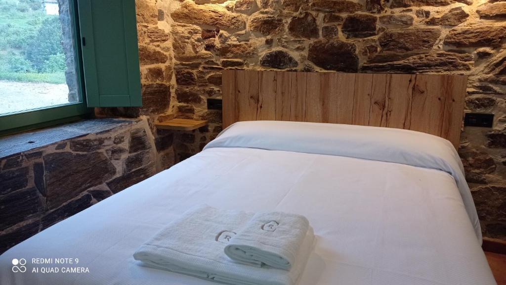 a bed with a towel with a face on it at Casa el rey 12 - Apartamentos Buenos Aires y Figueras 