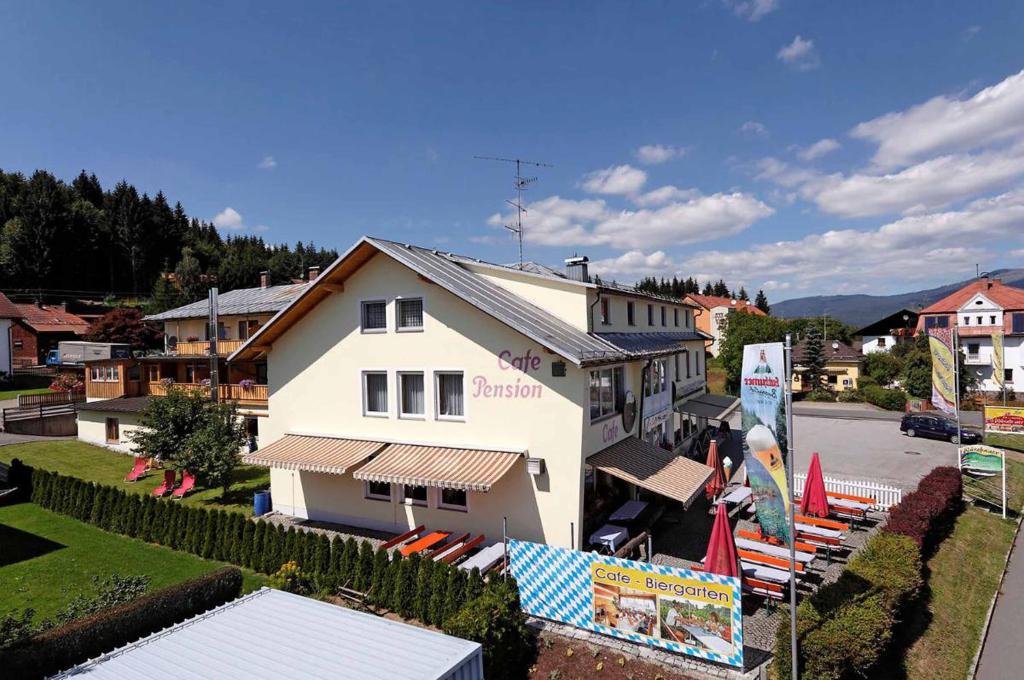 a white building with a sign in front of it at Hotel-Pension Würzbauer in Spiegelau