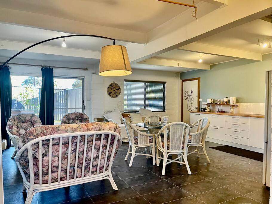 a kitchen and dining room with a table and chairs at Cute and Quirky Doves Nest Studio Walk to Werri Beach in Gerringong