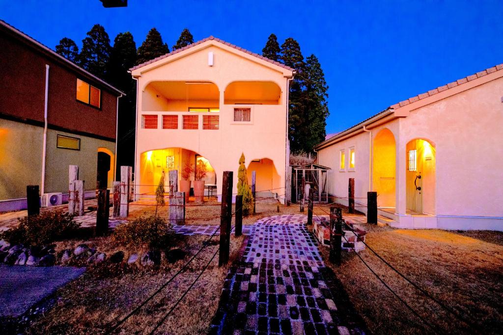 a house with a gate in front of it at 天からの贈り物 VillaMontpetre in Kirishima