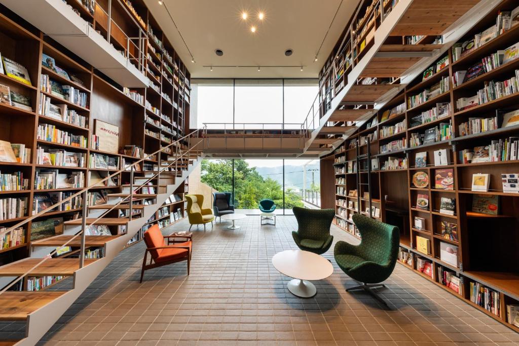 a library with chairs and bookshelves at Hakone Honbako in Hakone