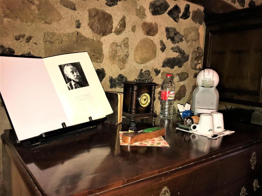 a table with a picture of a man on it at La Casa dels Poetes in Santa Pau