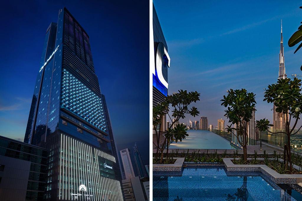 杜拜的住宿－Paramount Midtown Deluxe 1 BR Apartment with Full Burj-Khalifa View，一座高大的建筑,在城市前方有一个游泳池