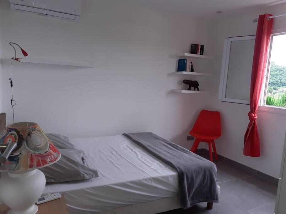 Postel nebo postele na pokoji v ubytování Invitation aux voyages