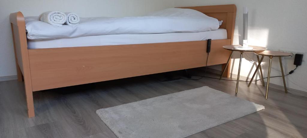 a bedroom with a bed with white sheets and a rug at Hanover Fair Rooms in Hannover