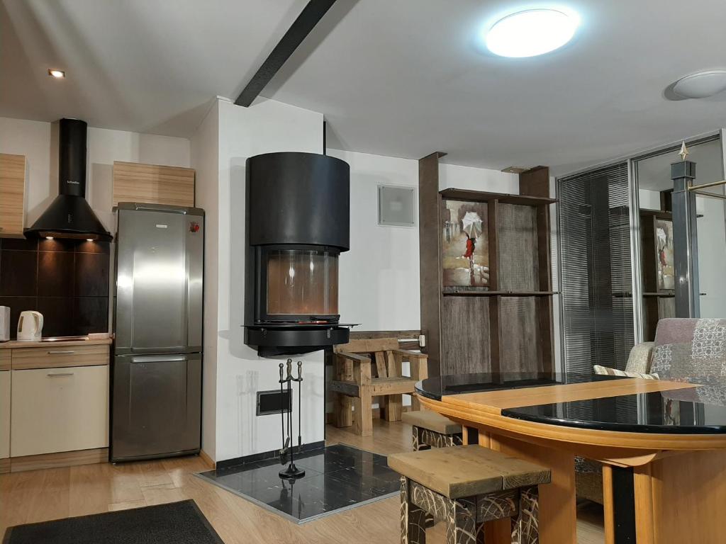 a kitchen with a table and a refrigerator at Free Airport Transport Inn in Rīga