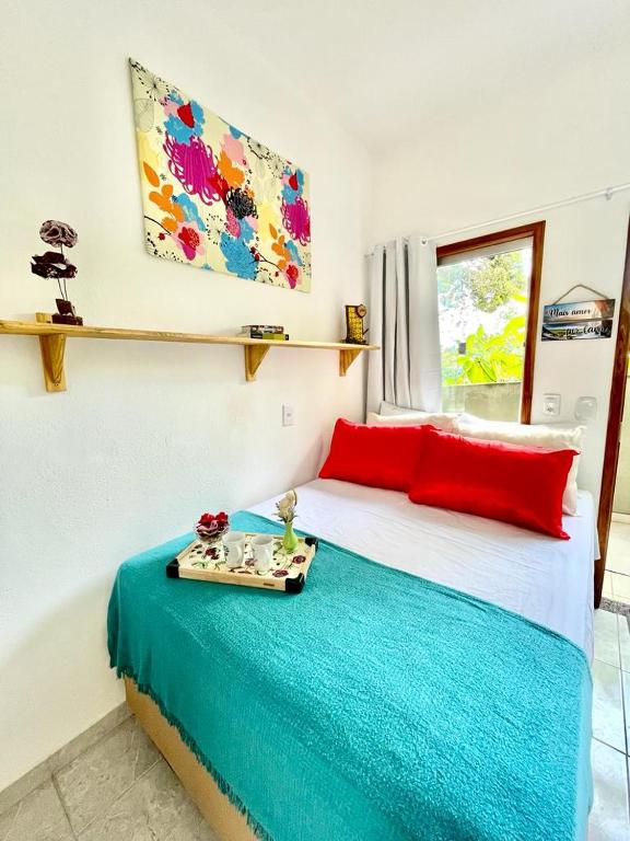 a bedroom with a bed with a tray on it at Vila Vasconcelos in Itacaré