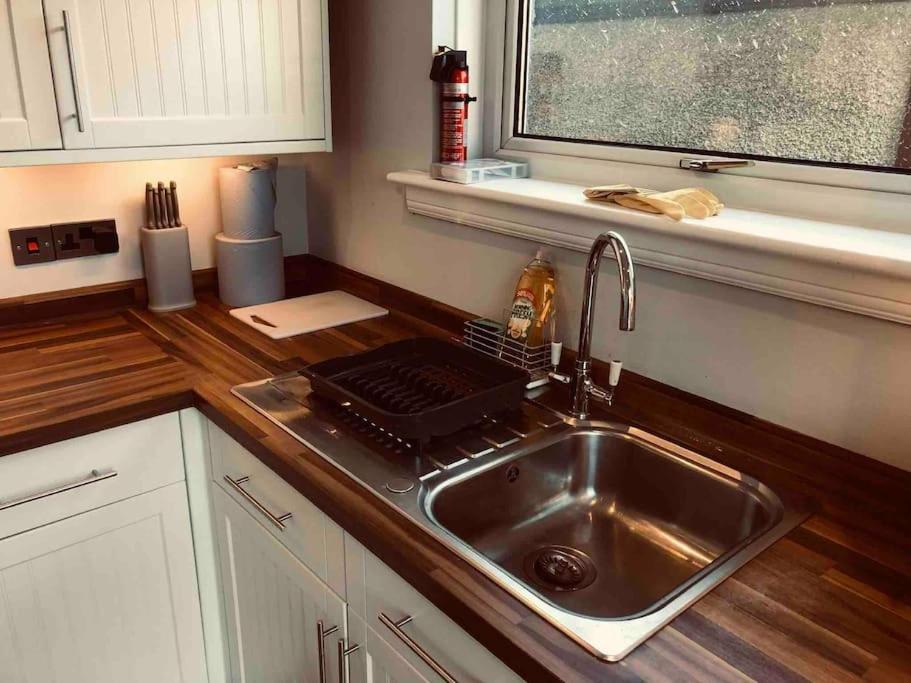a kitchen counter with a sink and a window at Dunfermline Home with Free Parking Near Amazon & M90 in Dunfermline