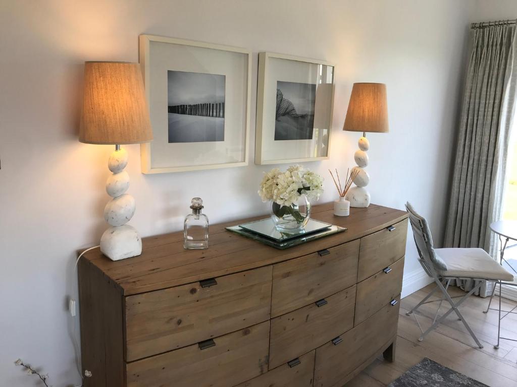 two lamps on top of a dresser in a room at Woodlands Coastal Apartment in Southerndown
