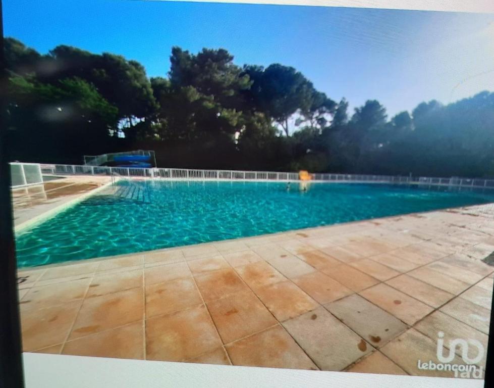 a swimming pool with a person in the water at Domaine de la coudoulière in Six-Fours-les-Plages