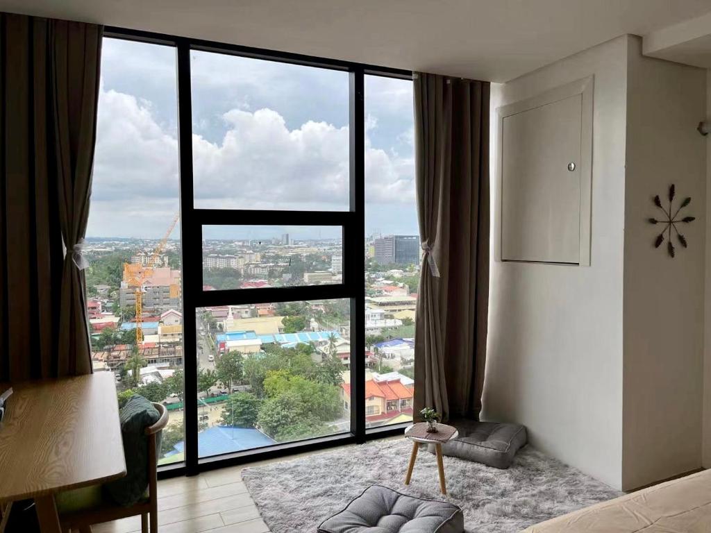um quarto com uma grande janela com vista em Condo in Cebu City Meridian with Netflix and WIFI, near Ayala and IT Park U03 em Cebu